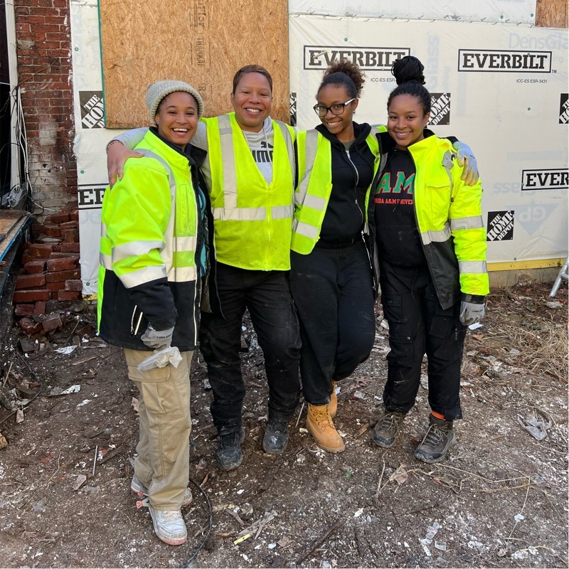 Aida Massie and female construction workers on site