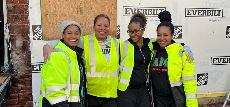 Aida Massie and female construction workers on site
