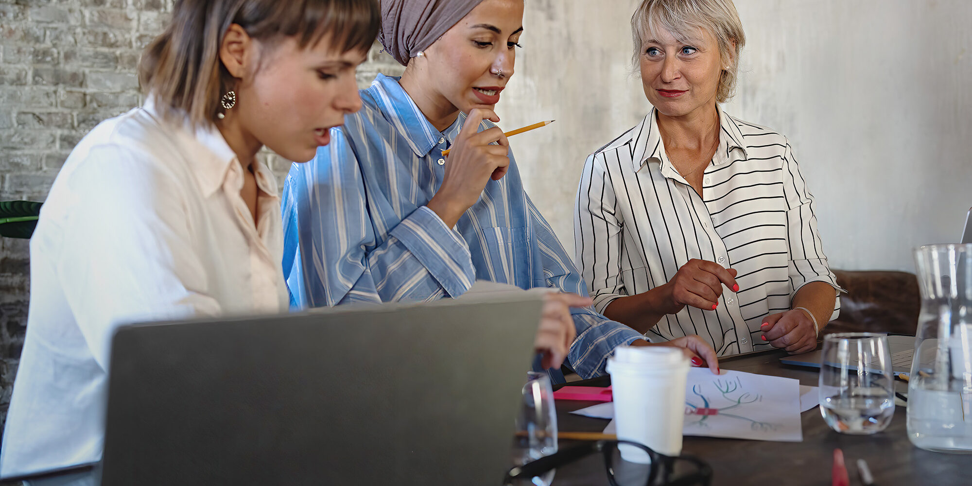 Three women collaborating in an office